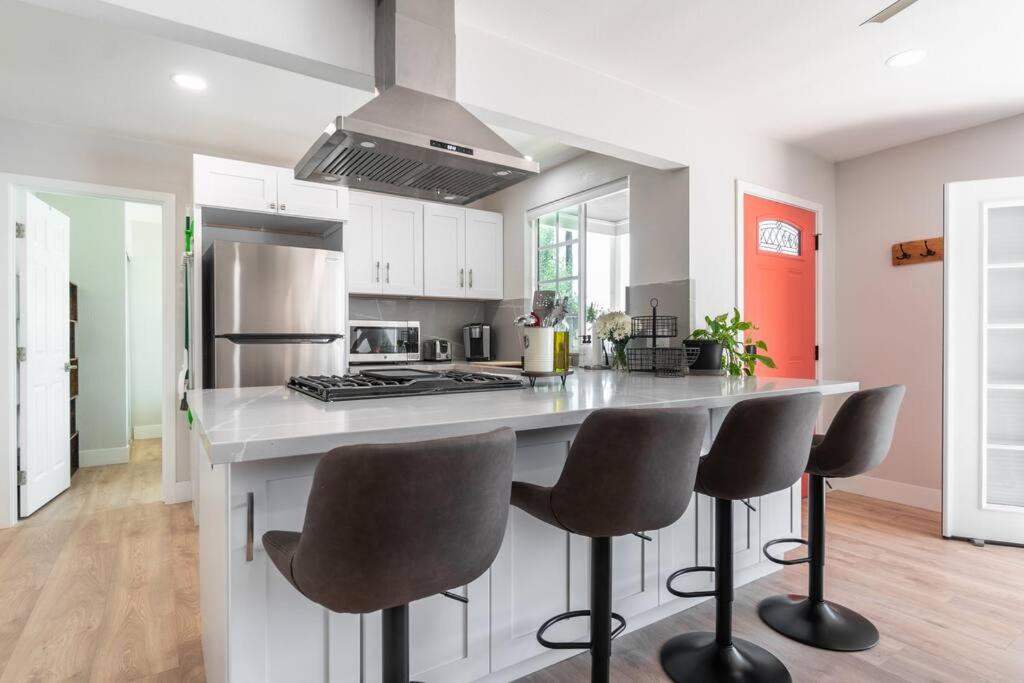 a kitchen with a counter with four bar chairs at A Place to Create Lasting Family Memories in San Diego