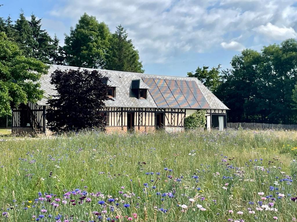 an old house with a field of flowers at Villa Fleurie in Grandchain