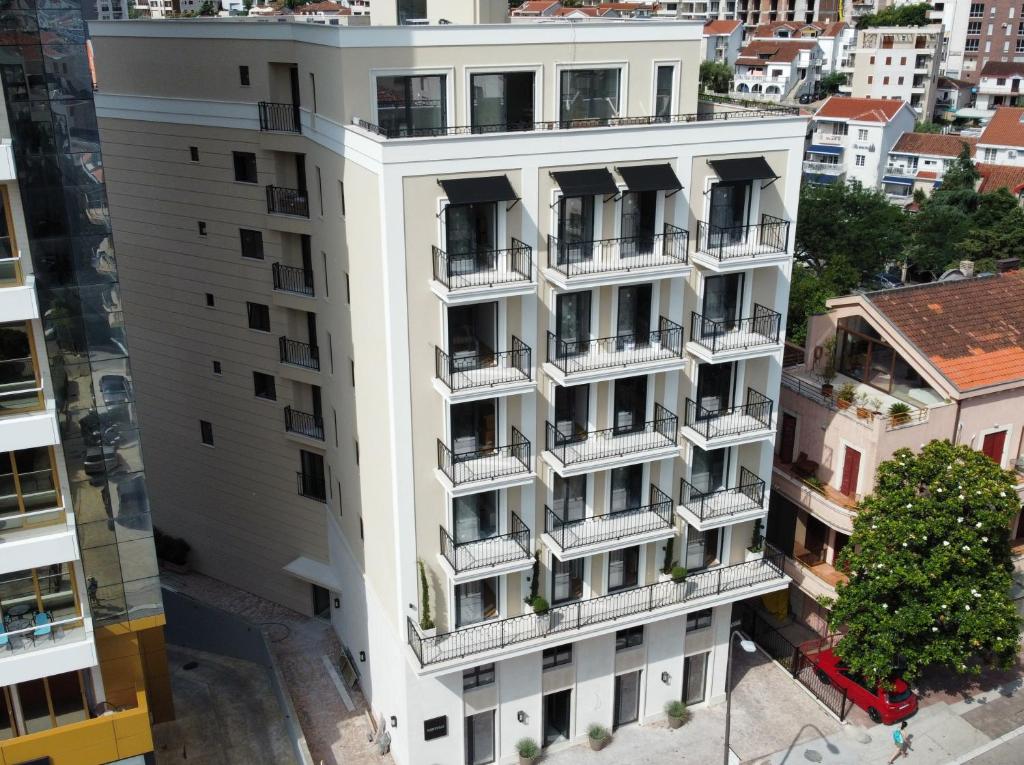 an overhead view of a white apartment building with balconies at Kondo Hotel Allure in Budva