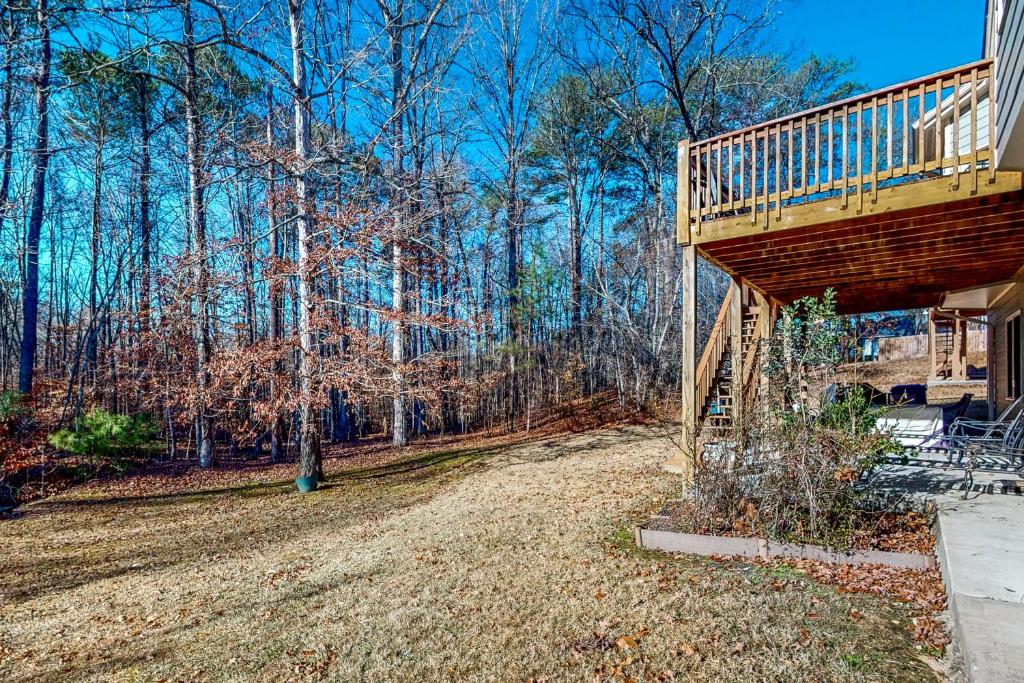 a deck on a house with trees in the background at The Perfect Getaway in Atlanta