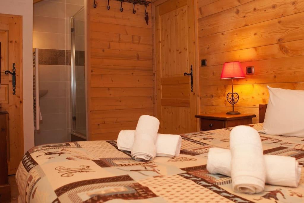 a bedroom with a bed with towels on it at L&#39;Aiglon - spacious 2-bedroom apartment with log fire in Sainte-Foy-Tarentaise