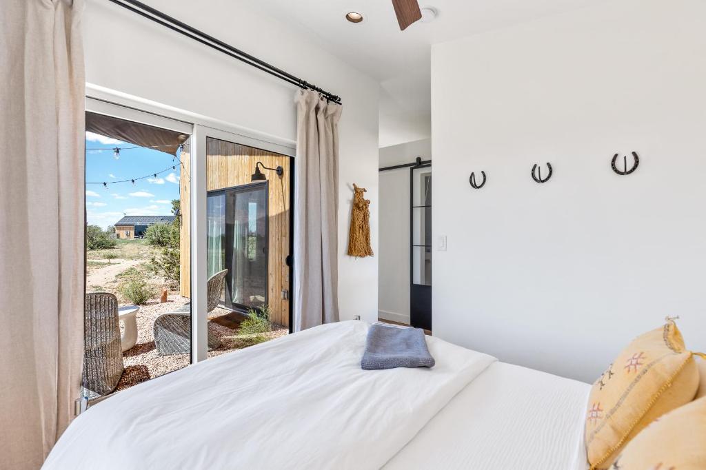 a bedroom with a white bed and a large window at The Grand Canyon Headquarters in Valle