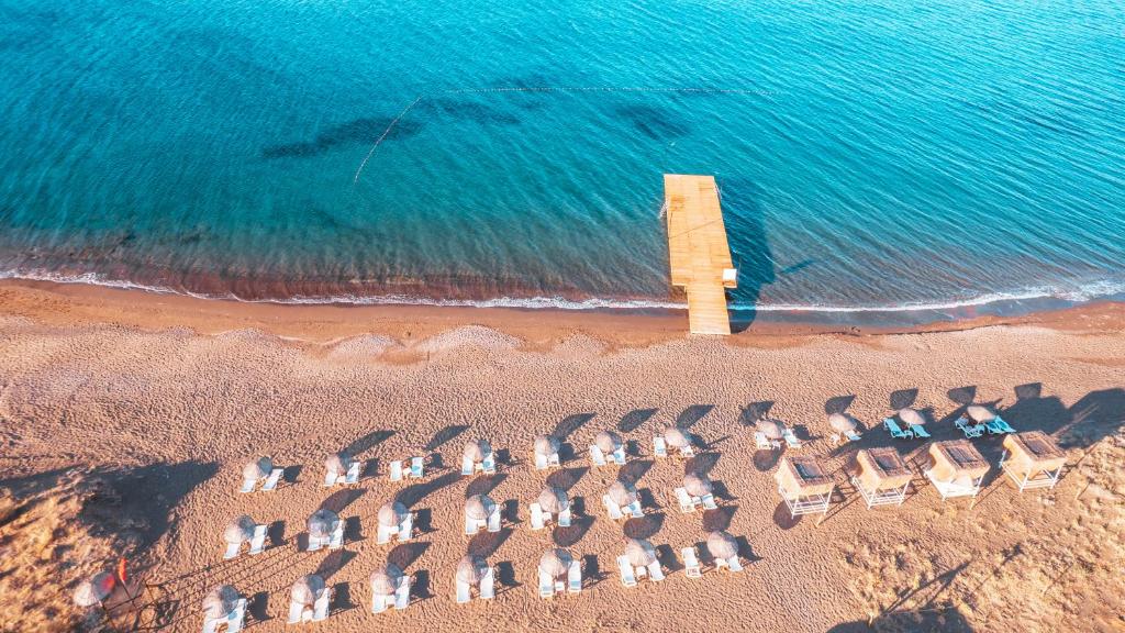 an aerial view of a beach with chairs and the ocean at Acroter Hotel Spa - Alcohol Extra All Inclusive in Datca