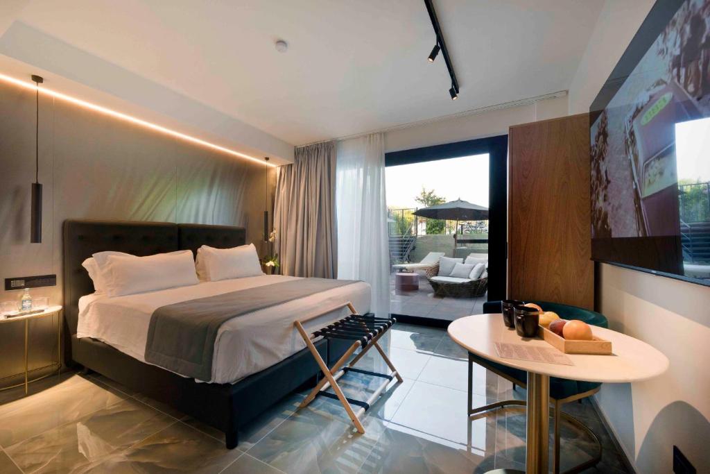 a hotel room with a bed and a table with a table at Boutique Hotel Sirmione in Sirmione