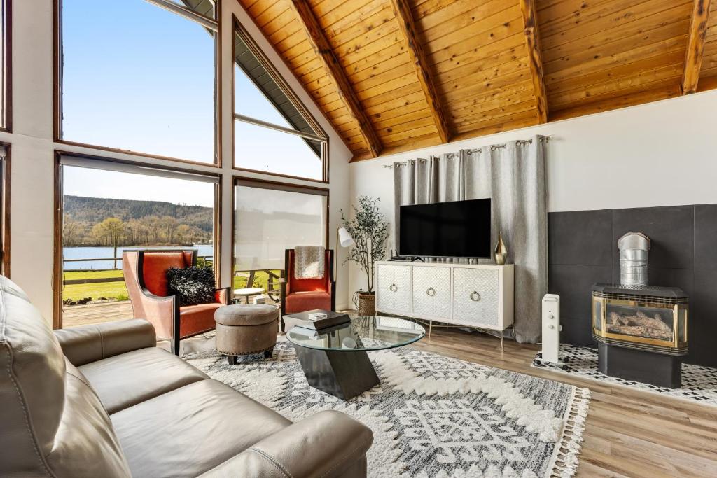 ein Wohnzimmer mit einem Sofa und einem TV in der Unterkunft Escape on the River in Cathlamet