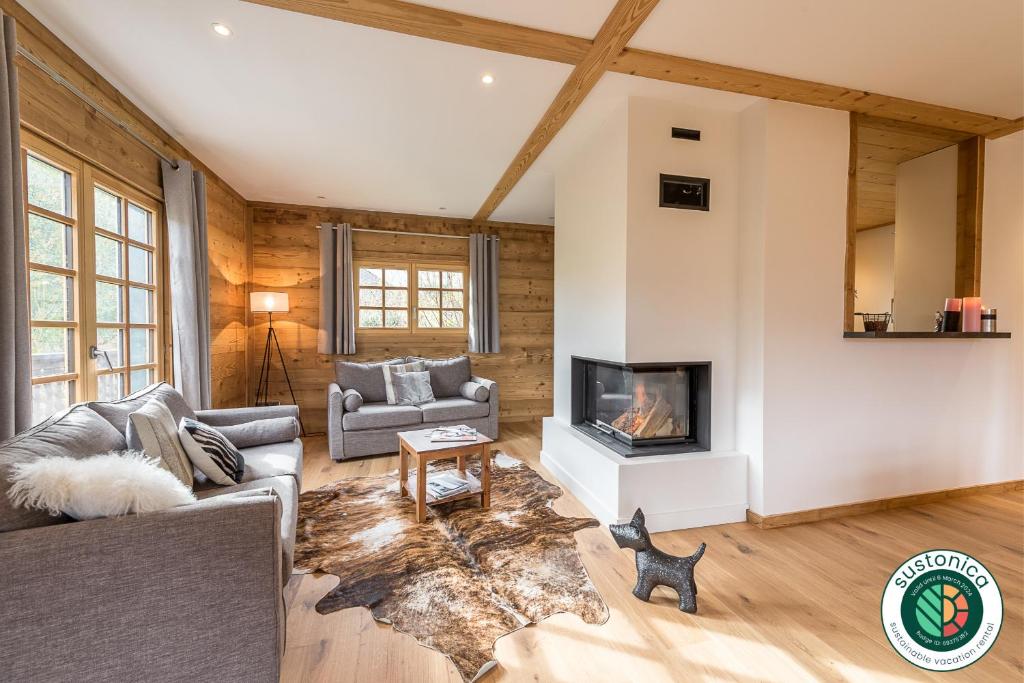 a living room with a couch and a fireplace at ST JORIOZ-Chalet renove des Grands Champs proche lac et piste cycable- LLA Selections by Location lac Annecy in Saint-Jorioz