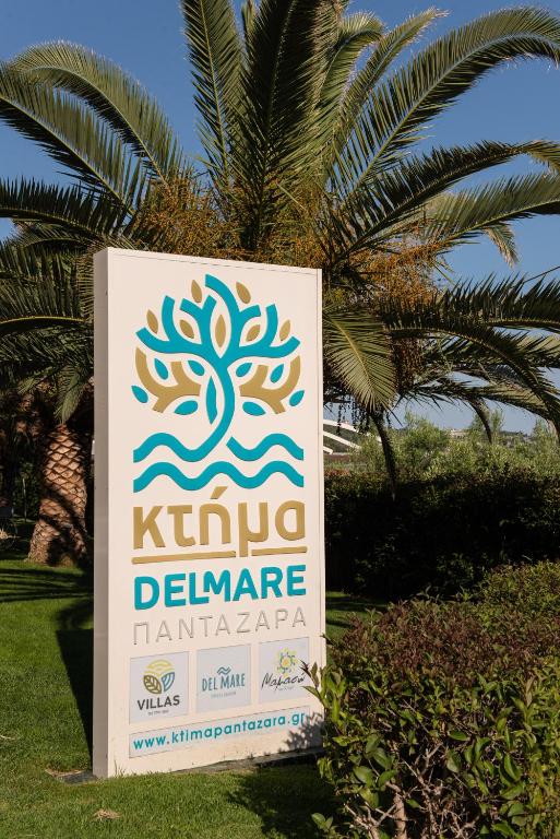 a sign for a clinic in front of a palm tree at Ktima Delmare Pantazara in Nea Skioni