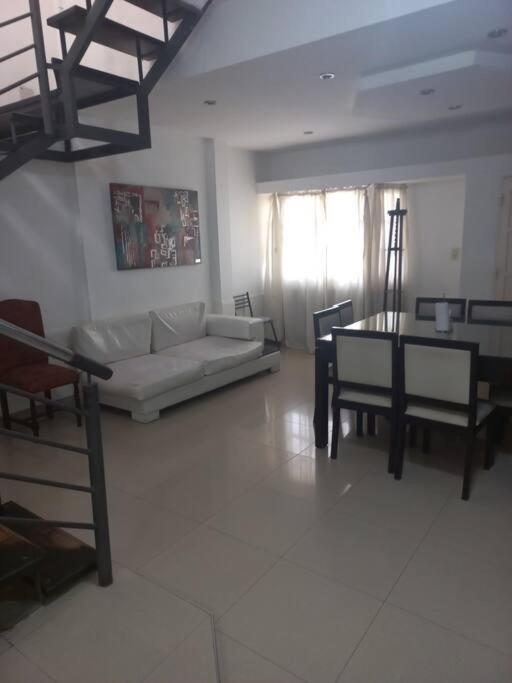 a living room with a couch and a table at La Casa de Los Mellis.. in La Banda