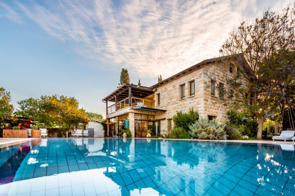 a large swimming pool in front of a building at Grand Vista Boutique Hotel And Spa in Yuval