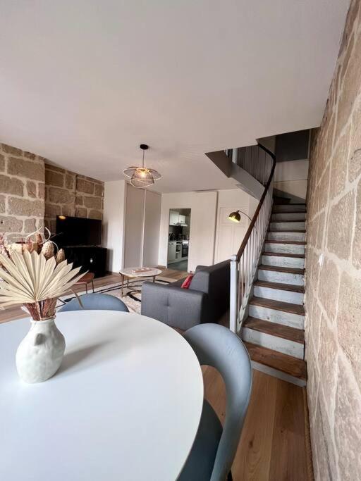 a room with a table and chairs and a staircase at Élégante &amp; Design Casa Churchill - Brive Centre in Brive-la-Gaillarde