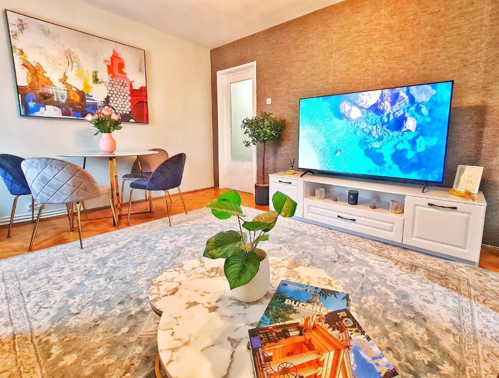 a living room with a large flat screen tv at Arc de Triomphe BlissBoutique in Bucharest
