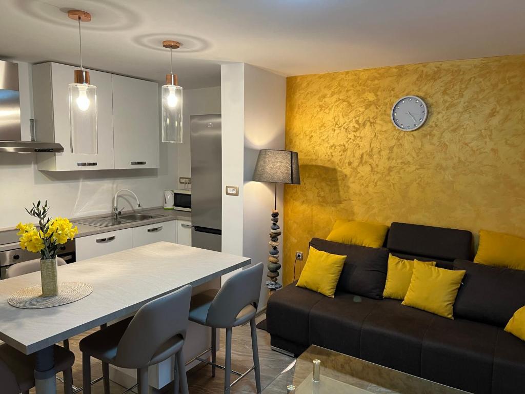 a kitchen and living room with a couch and a table at Mali Stan Opatija in Opatija