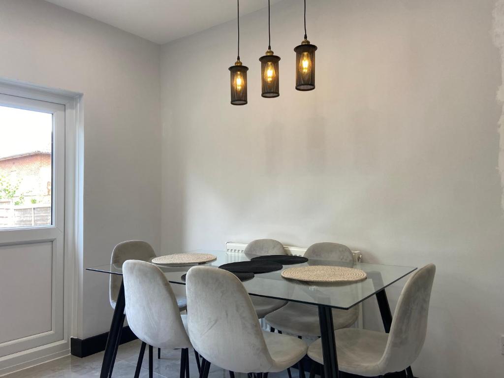 a dining room with a table and chairs at North West London Escape in Mill Hill