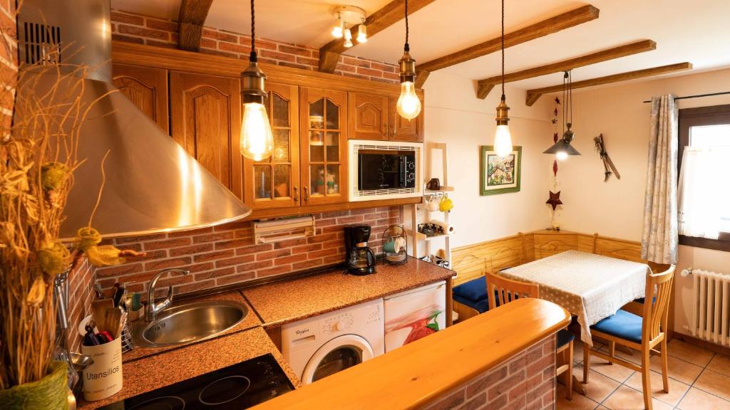 a kitchen with a sink and a counter top at Apartamentos Formigal - Admite mascotas- in Formigal