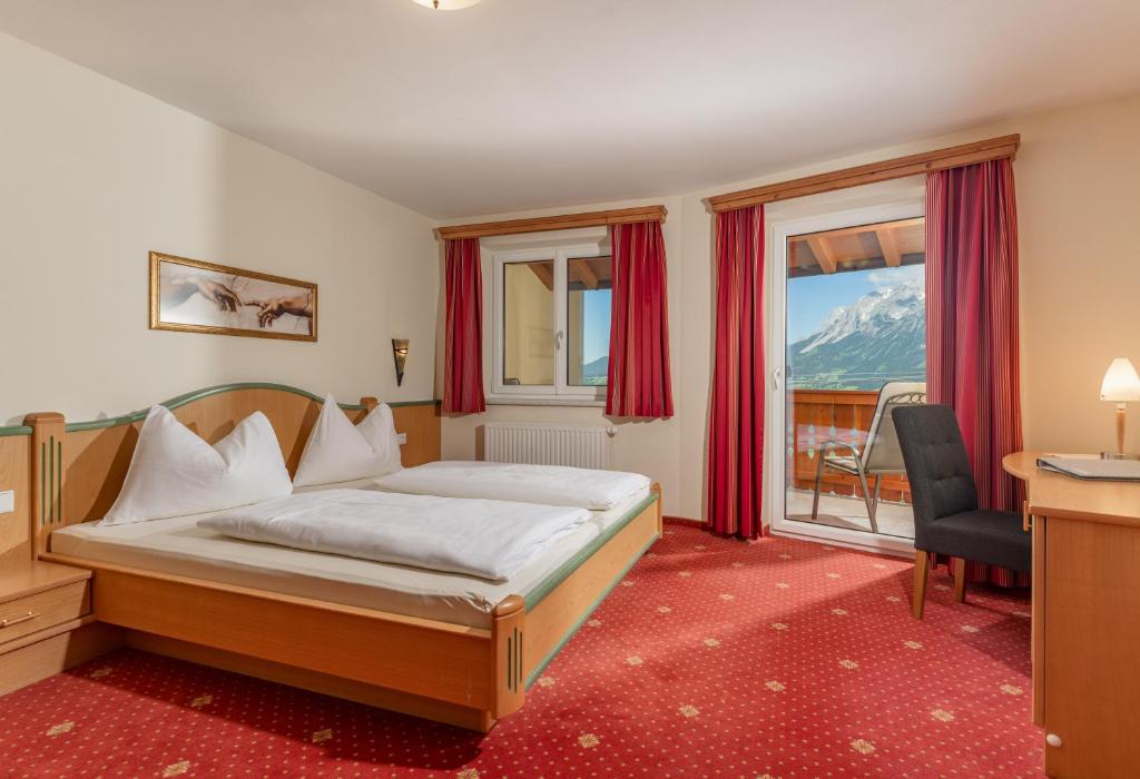 A bed or beds in a room at Apparthaus Taxegger