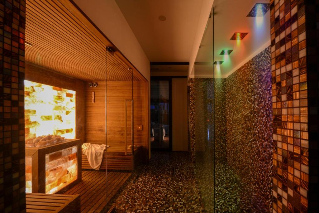 a bathroom with a shower with a glass door at Grand Hotel Masseria Santa Lucia in Ostuni
