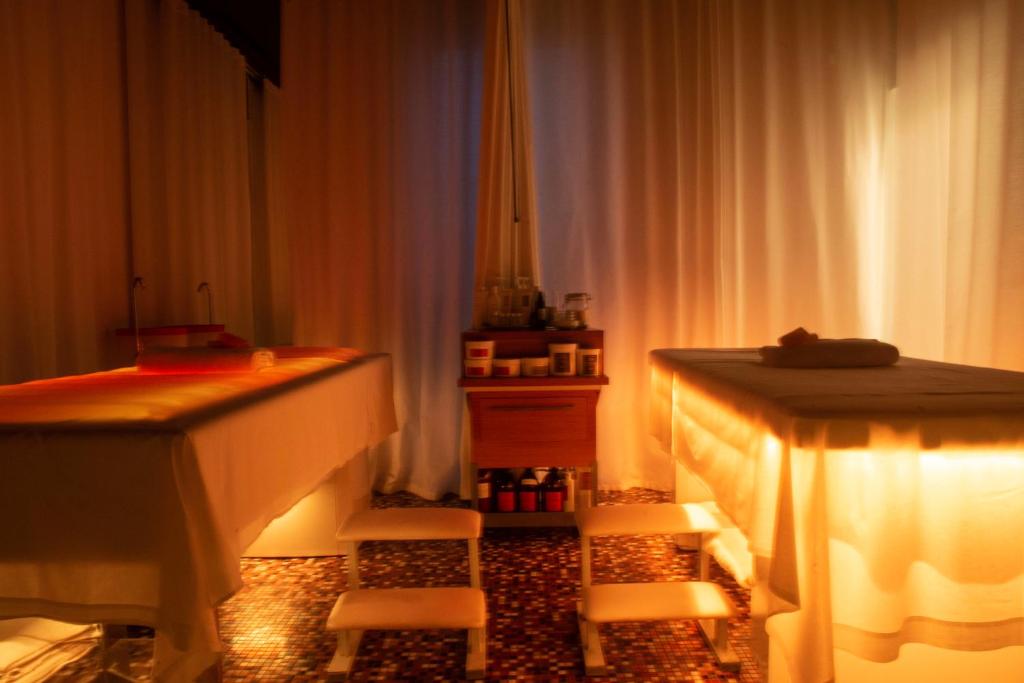 a room with two tables and two chairs and lights at Grand Hotel Masseria Santa Lucia in Ostuni