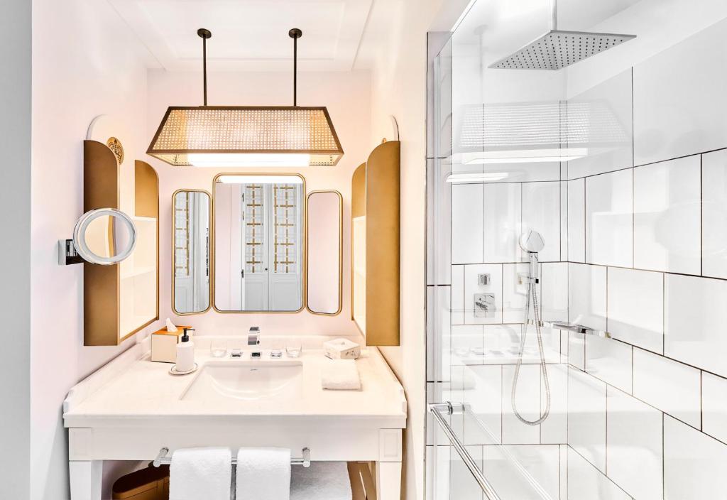 a bathroom with a sink and a shower at Carlton Cannes, a Regent Hotel in Cannes