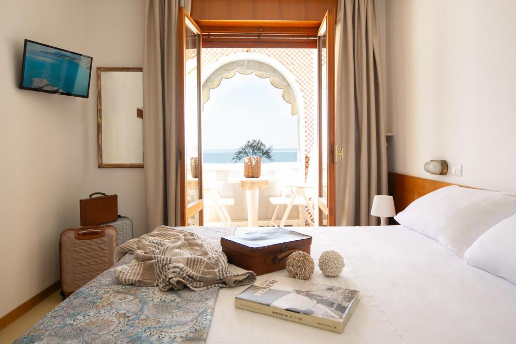 a bedroom with a bed with a view of the ocean at Villa Marin in Grado
