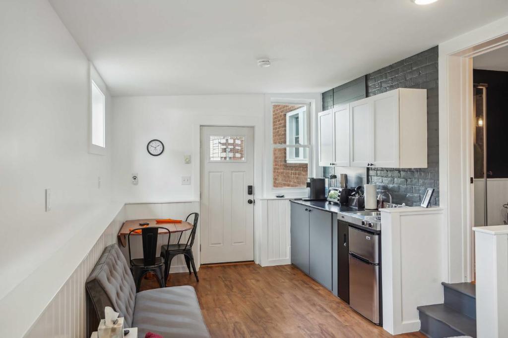 a kitchen with white cabinets and a table at Kingston Crawfish Cottage Near Catskills! in Kingston