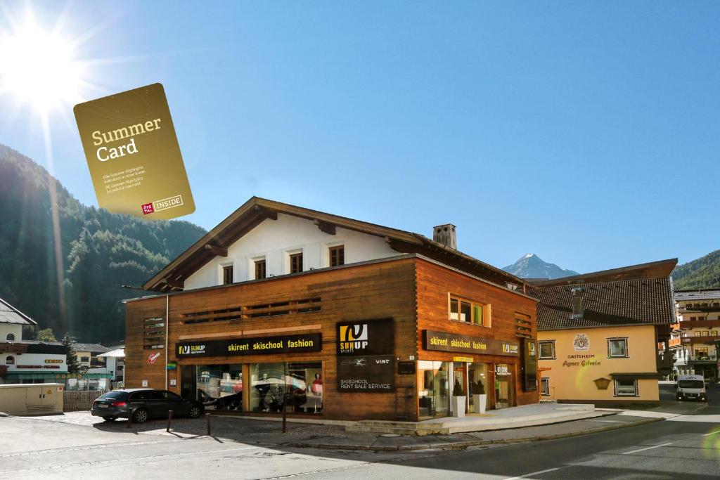 a building with a sign in front of it at Sunup Appartements Sölden in Sölden