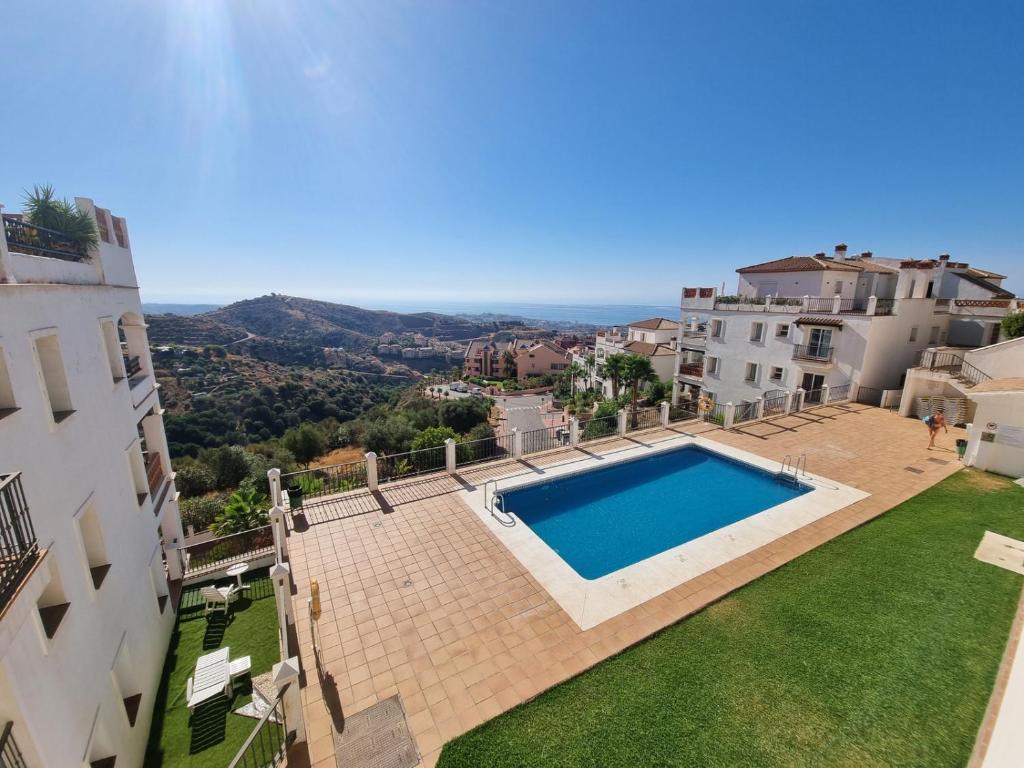 an image of a swimming pool in the middle of a building at Elegant apartment with fantastic views At the top of Calahonda in Sitio de Calahonda