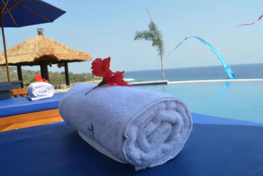 a rolled up towel with a leaf on top of a pool at Shankara Parada Villas in Amed