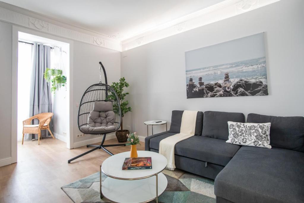 a living room with a couch and a table at Tendency Apartments Miro 6 in Barcelona