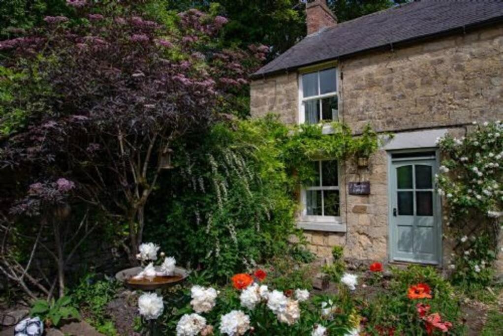 a stone house with flowers in front of it at Moor View in Lockton