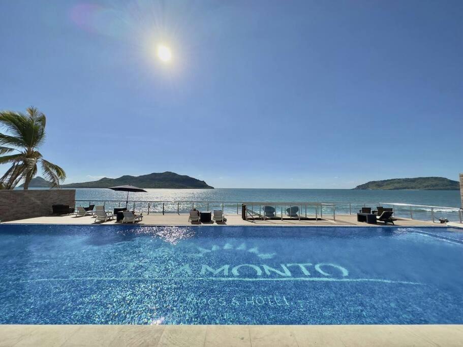 a swimming pool with the ocean in the background at pie de playa y con vista al mar by G P S rentas in Mazatlán