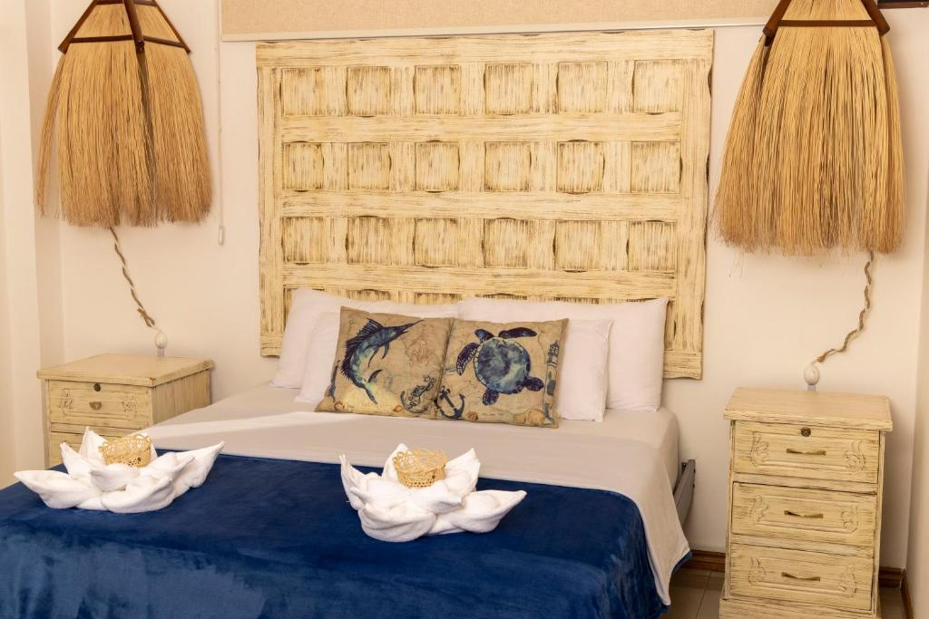 Postel nebo postele na pokoji v ubytování Galapagos Planet Hotel
