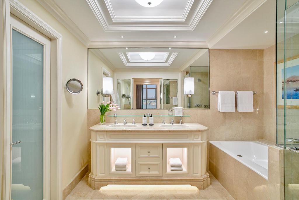 a bathroom with a sink and a tub and a mirror at Four Seasons Hotel Cairo at Nile Plaza in Cairo
