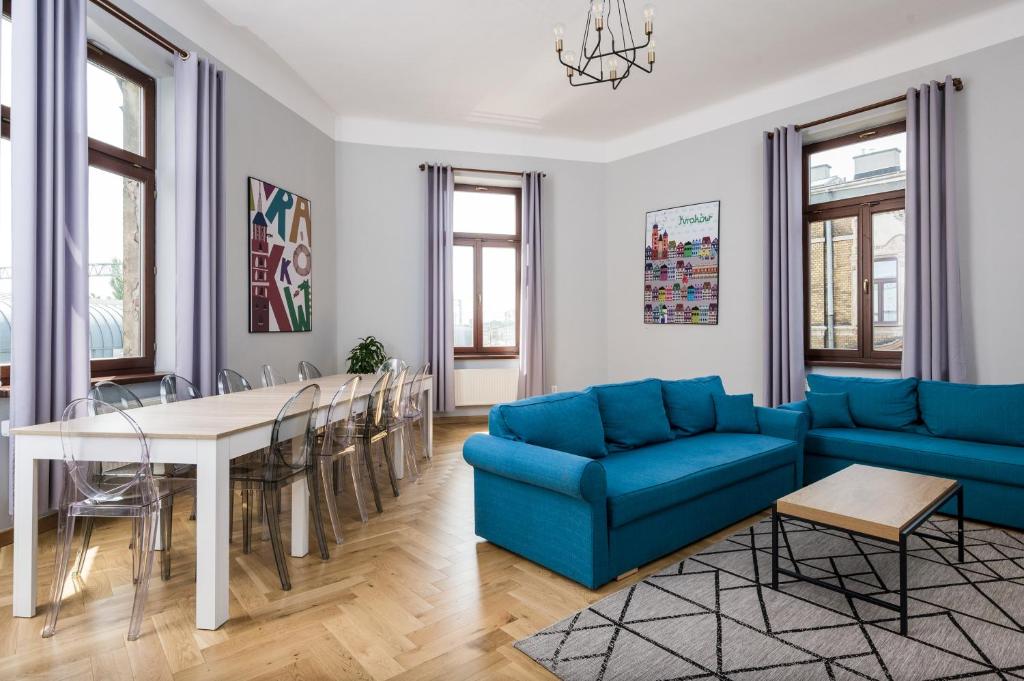 a living room with a blue couch and a table at Beautiful apartment, great location, Old Town & Kazimierz in Kraków