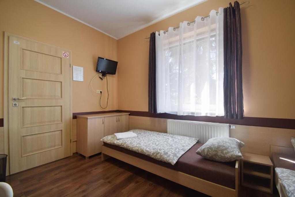 Postel nebo postele na pokoji v ubytování Pensjonat Paskal
