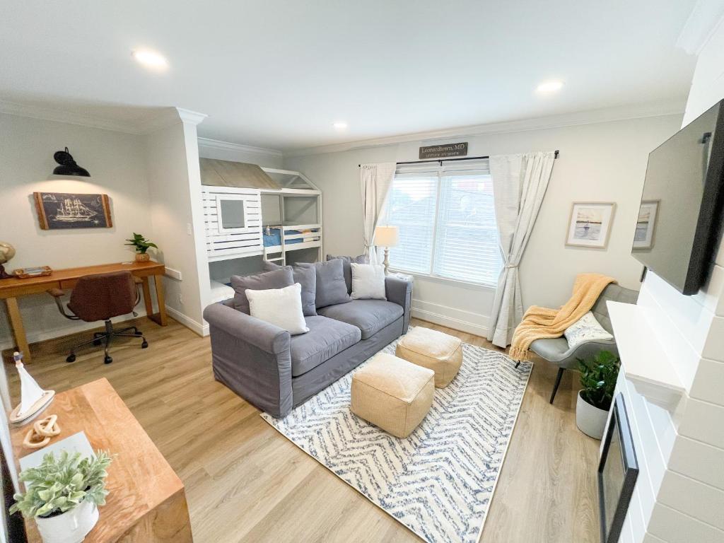 a living room with a couch and a table at Retreat at Fenwick in Leonardtown