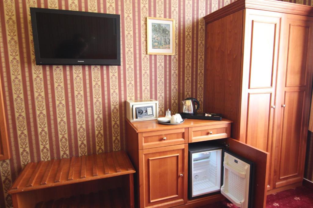 a living room with a tv on a wall at Old Prague Hotel in Prague