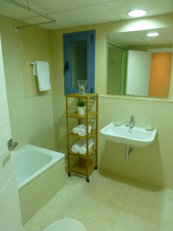 a bathroom with a sink and a bath tub and a sink at Casa Valdevaqueros in Tarifa