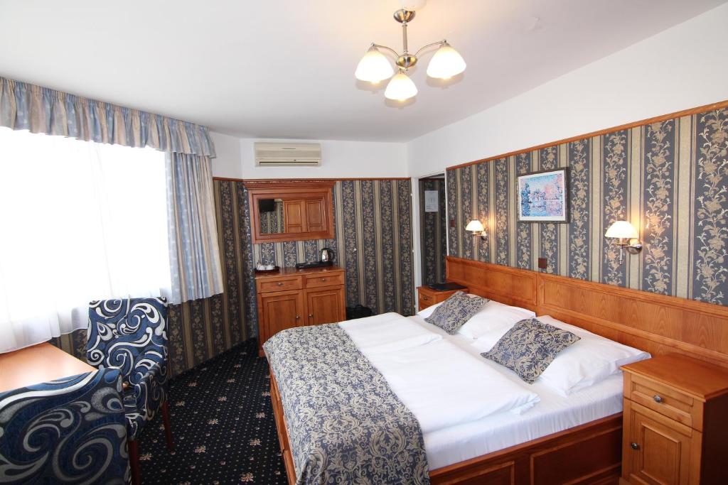 a bedroom with a large bed and a window at Old Prague Hotel in Prague