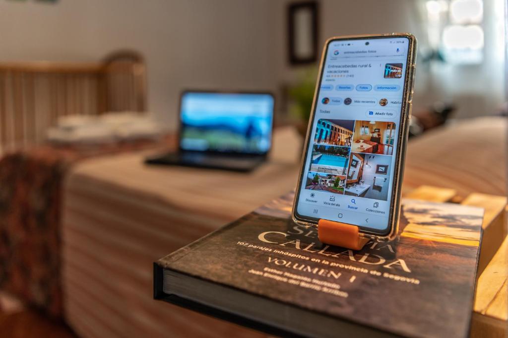 a cell phone sitting on top of a book at Gran apartamento a 55 min de Madrid confort, calidad & salón de tertulias in Segovia