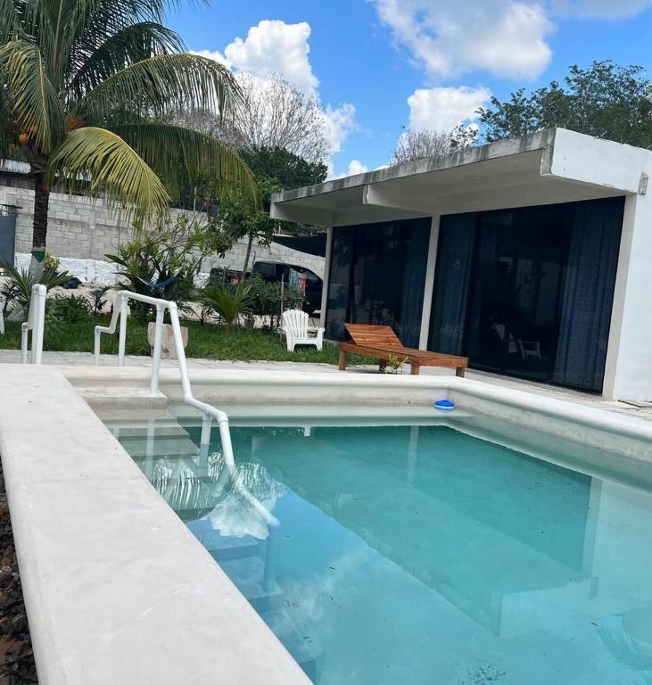 a swimming pool in front of a house at King's Tuuch Bacalar - Cerca de la Laguna in Bacalar