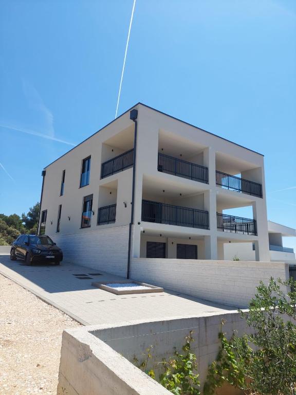 a building with a car parked in front of it at Markioli Residence in Sevid