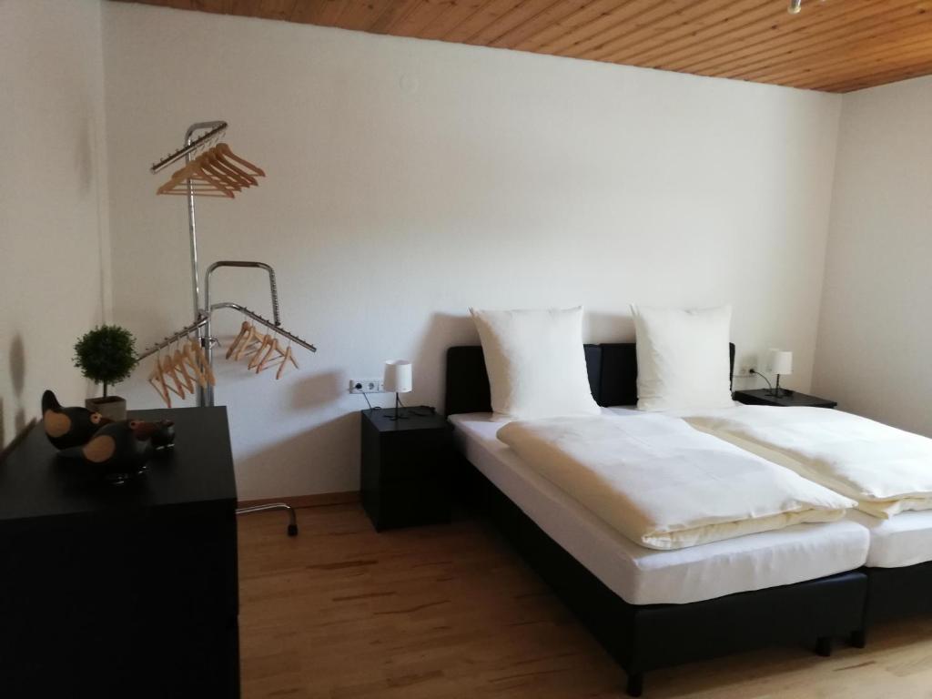 a bedroom with a large bed with white sheets at Ferienwohnung Sauerland in Drolshagen