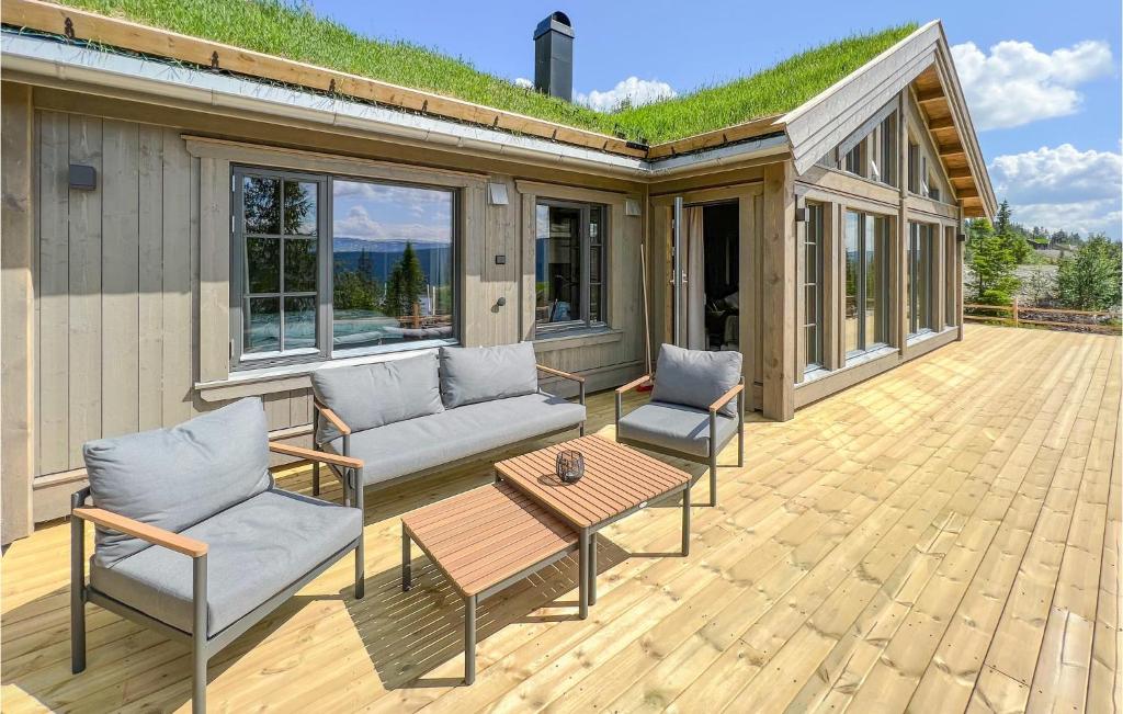 a patio with two couches and a table and chairs at Stunning Home In Gl With Sauna, Wifi And 4 Bedrooms in Gålå