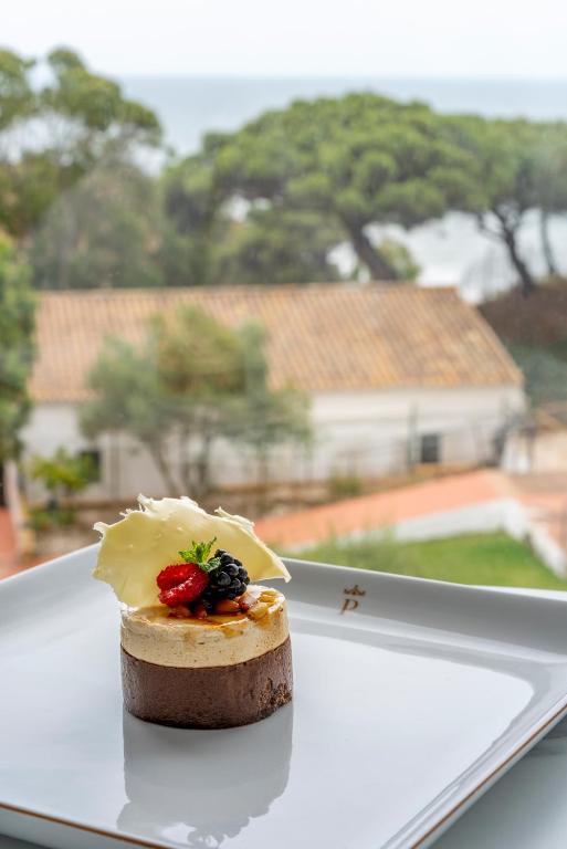 a piece of food sitting on a white plate at Parador de Mazagón in Mazagón