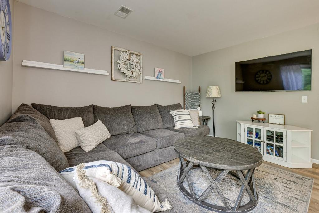 a living room with a gray couch and a table at Dog-Friendly Baraboo Vacation Rental with Yard! in Baraboo
