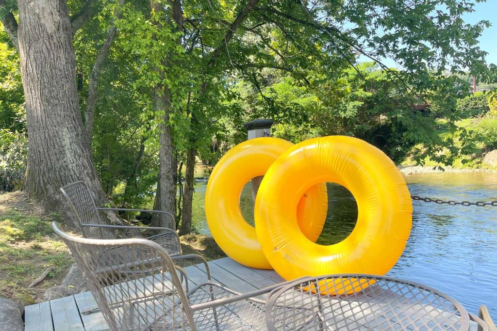 a large yellow object sitting on a table near the water at Mill Stream Cottage in Pigeon Forge