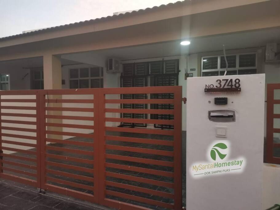 una casa con una valla y un medidor de gas en MySantai Homestay Padang Serai, en Padang Serai