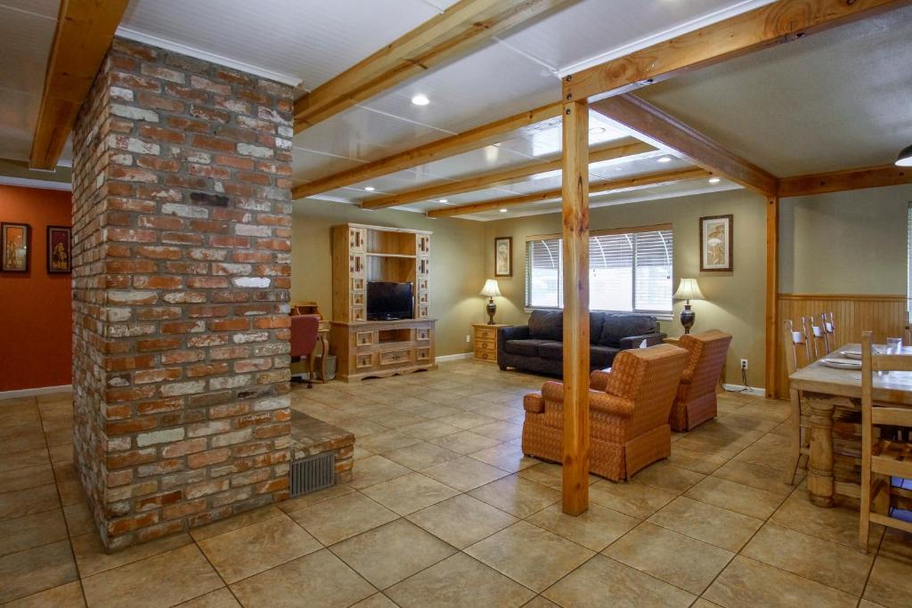 a living room with a brick fireplace and a couch at Charm Motel & Suites in Burney