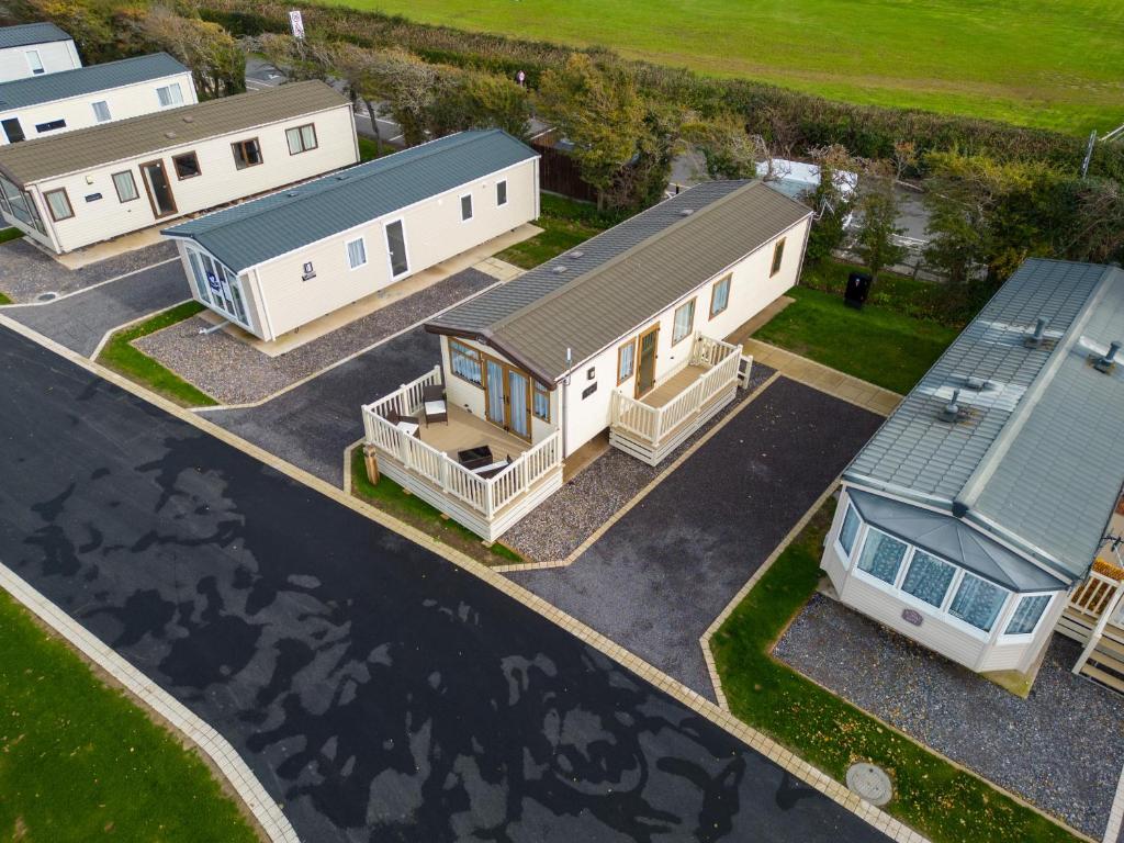 an aerial view of three mobile homes in a parking lot at Althea, White Horse, Seal Bay Resort in Selsey