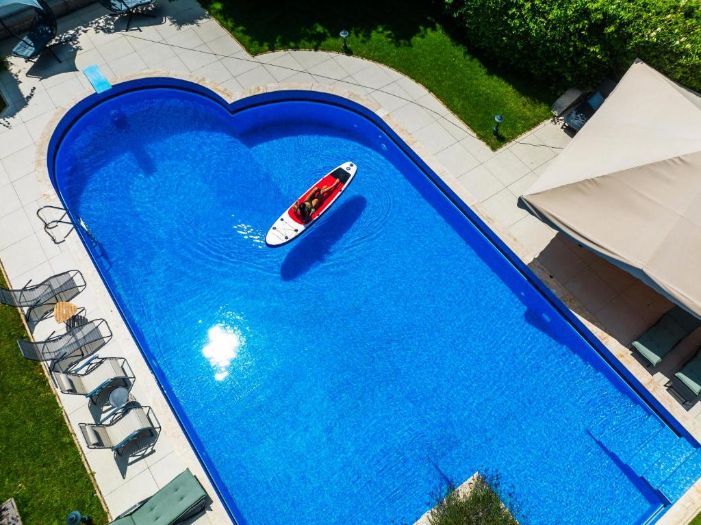 an overhead view of a boat in a large swimming pool at Füge Villa Luxury & Wellness in Balatonfüred